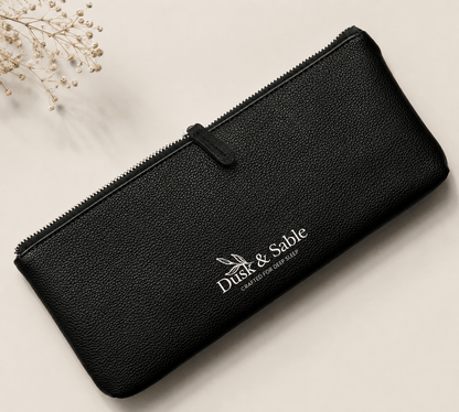 Black leather wallet with 'Dusk & Sable' logo on a light background